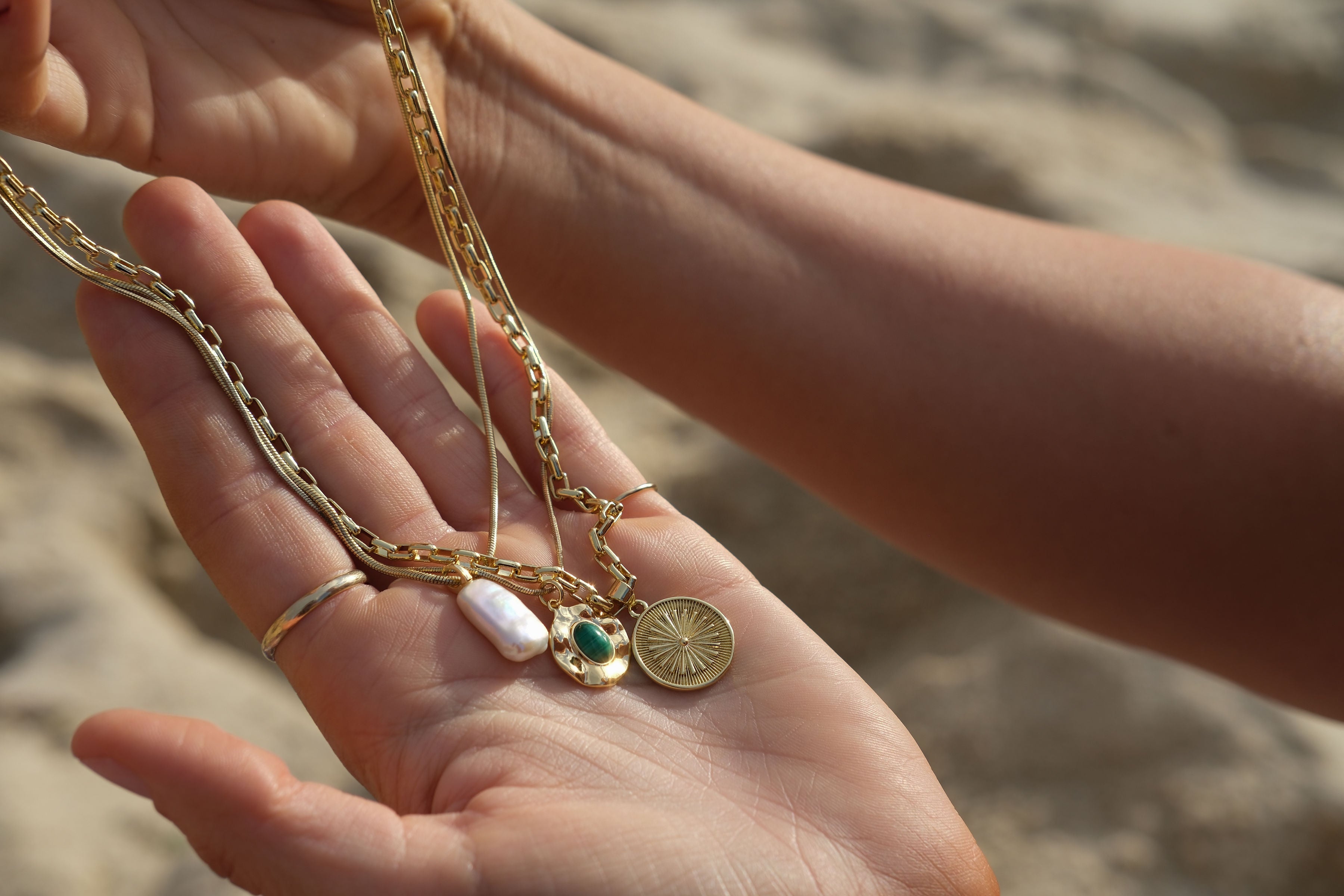 Handcrafted gold-filled jewellery held in hand - Tide & Stone Jewellery Australia